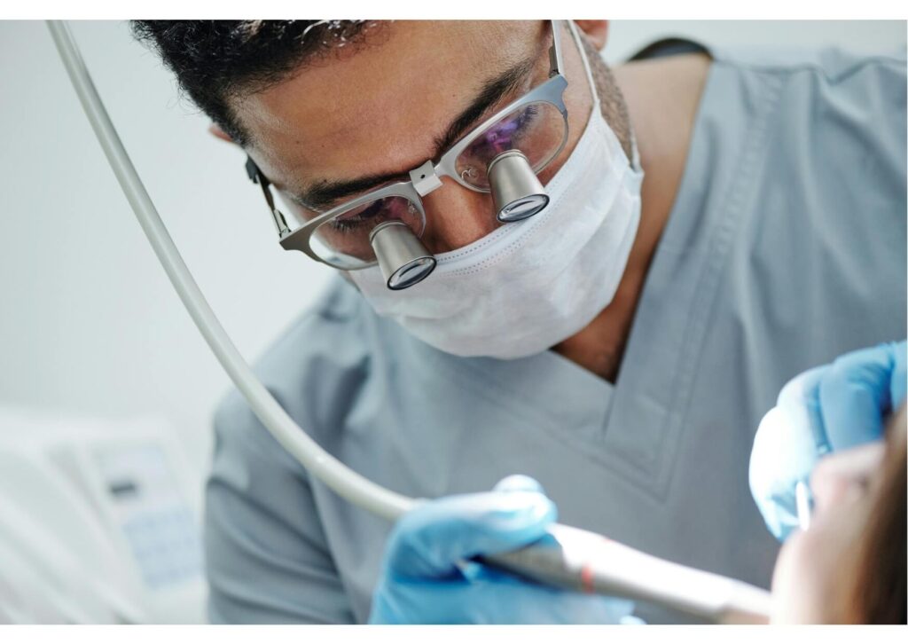 Dentist performing a dental implant procedure during a consultation about dental implant costs and treatment options