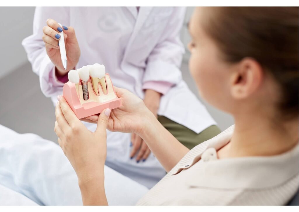 Patient reviewing a dental implant model during a consultation about the pros and cons of dental implants