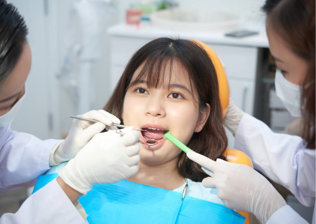 Patient receiving a dental examination to assess tooth development and determine whether a new tooth will grow back after tooth loss.