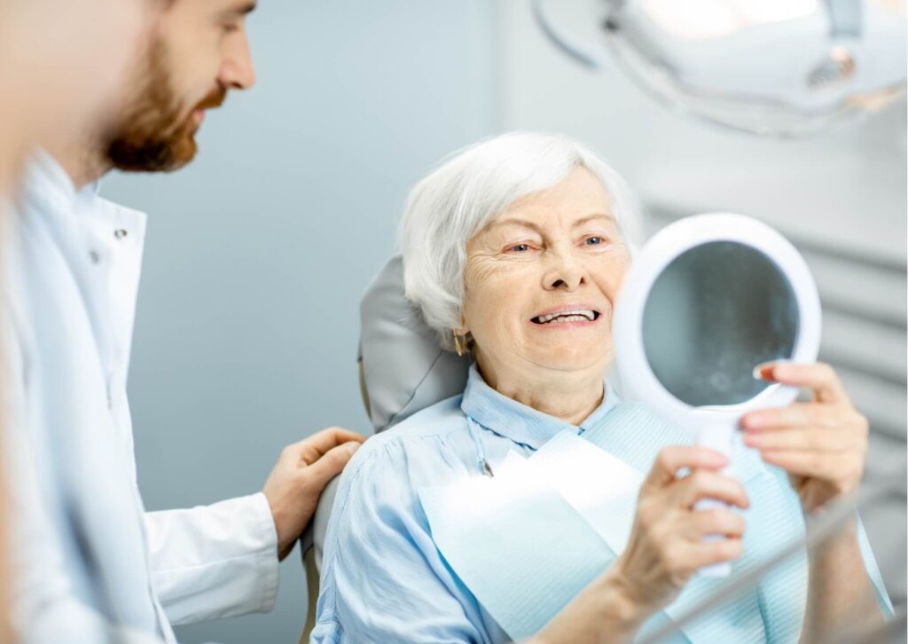 Older adult reviewing their smile with a dentist, showing that age alone does not determine when it is too late to get dental implants.